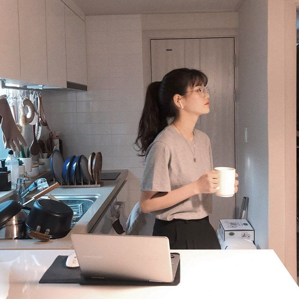 Young girl in the kitchen holding coffee working on the easiest part-time job that students can do